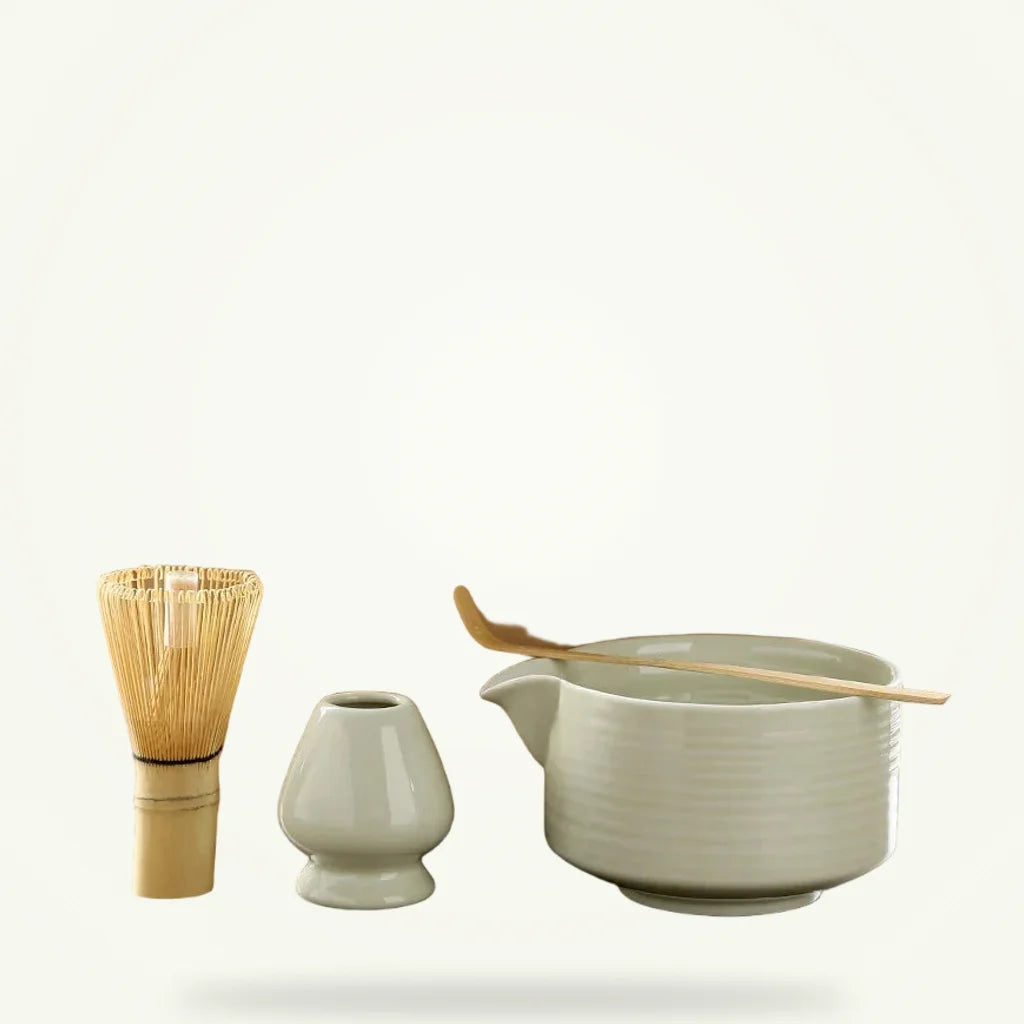 Japanese matcha set 4 piece with ceramic bowl, bamboo chasen whisk, holder and scoop on plain background