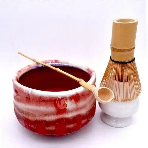 Japanese red tea bowl with bamboo whisk