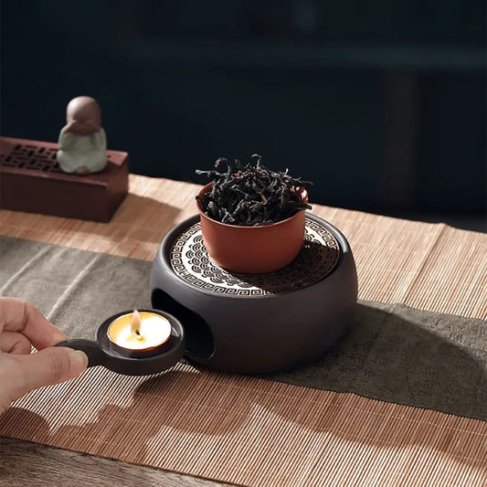 Japanese tea warmer sculpted grid holding ceramic teapot from above