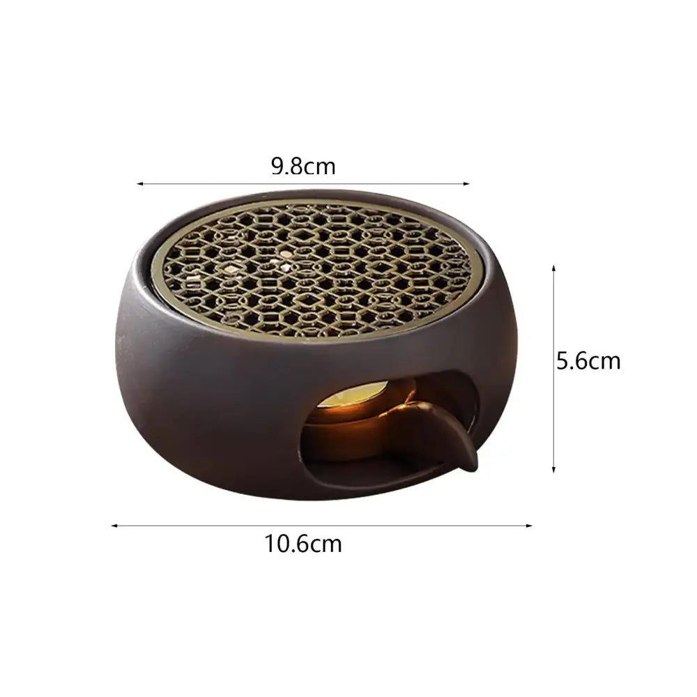 Japanese-style sculpted grid warmer supporting small ceramic teapot during use