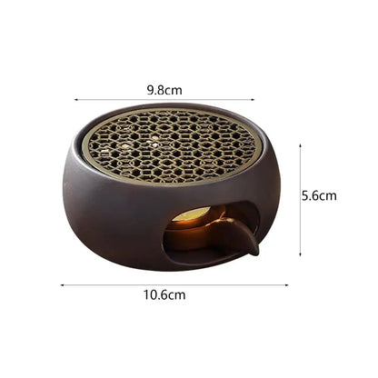 Japanese-style sculpted grid warmer supporting small ceramic teapot during use
