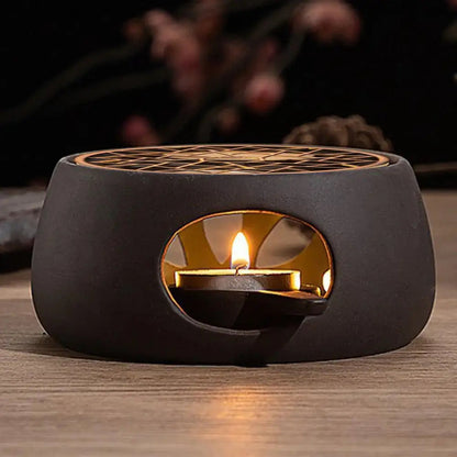 Ceramic teapot warmer showing ventilation holes and tea light candle inside base