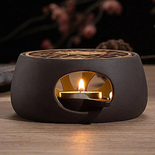 Ceramic teapot warmer showing ventilation holes and tea light candle inside base
