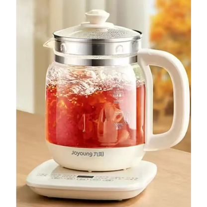 Electric teapot pouring hot water into cup