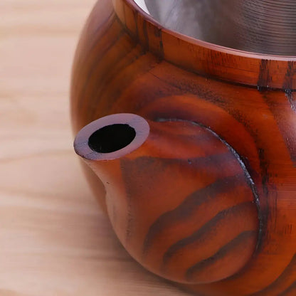 Close-up of kyusu wood teapot spout pouring tea