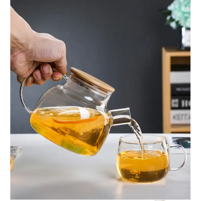 1-liter glass teapot pouring brewed loose leaf tea into a cup