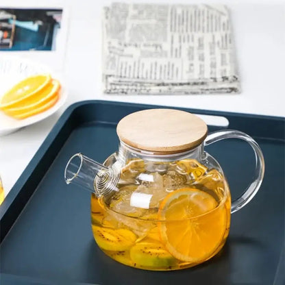 Glass teapot with stainless steel infuser basket and loose leaf tea steeping inside