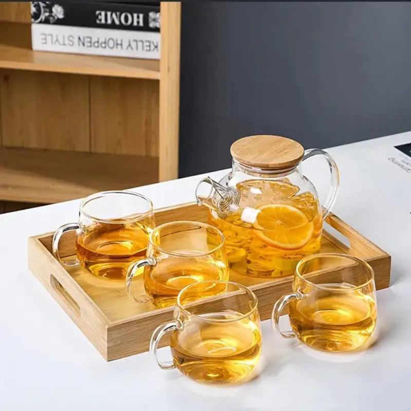 Close-up of removable stainless steel infuser basket and glass teapot lid