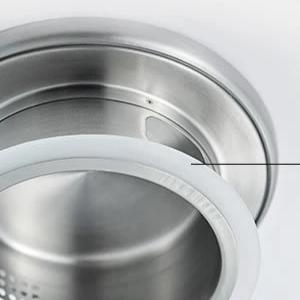 Removable stainless steel infuser basket inside large glass teapot