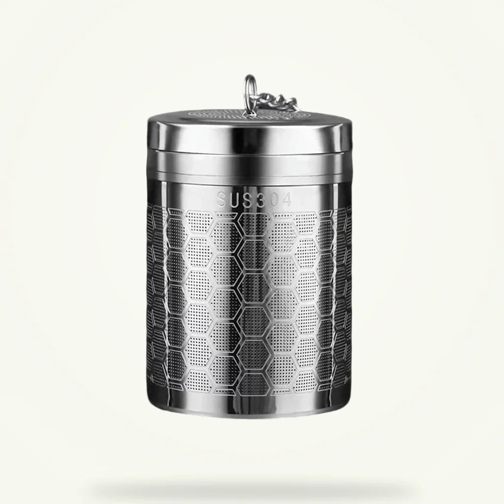 Large stainless steel tea infuser for loose leaf tea on plain background