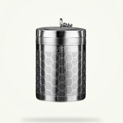 Large stainless steel tea infuser for loose leaf tea on plain background