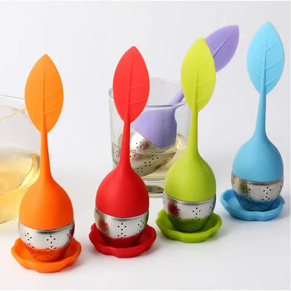 Leaf shaped tea infuser resting on a mug of hot tea
