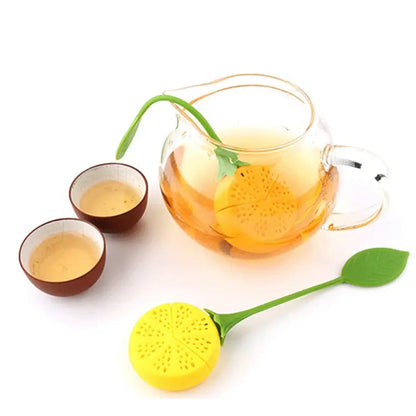 Lemon infuser for tea sitting on a saucer with a cup of tea