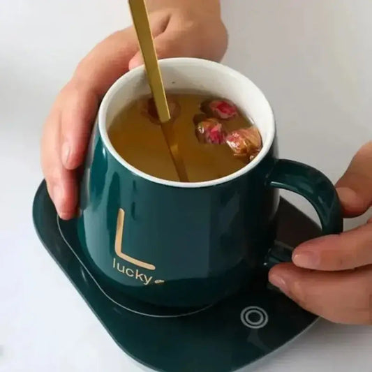 Teapot warmer set with mug and spoon on wooden table