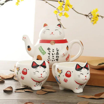 Japanese porcelain lucky cat teapot with two matching teacups