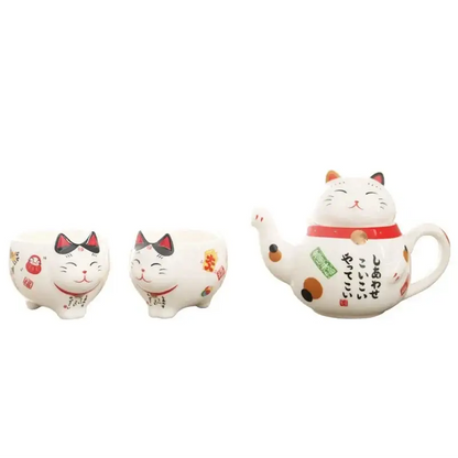 Complete lucky cat tea set showing teapot and two cups from above
