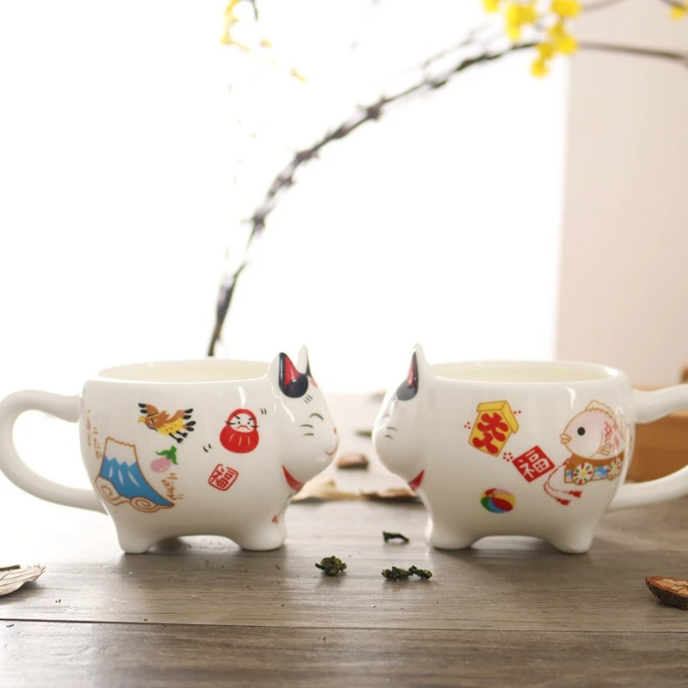 Lucky cat tea cup cat shaped handle held in hand