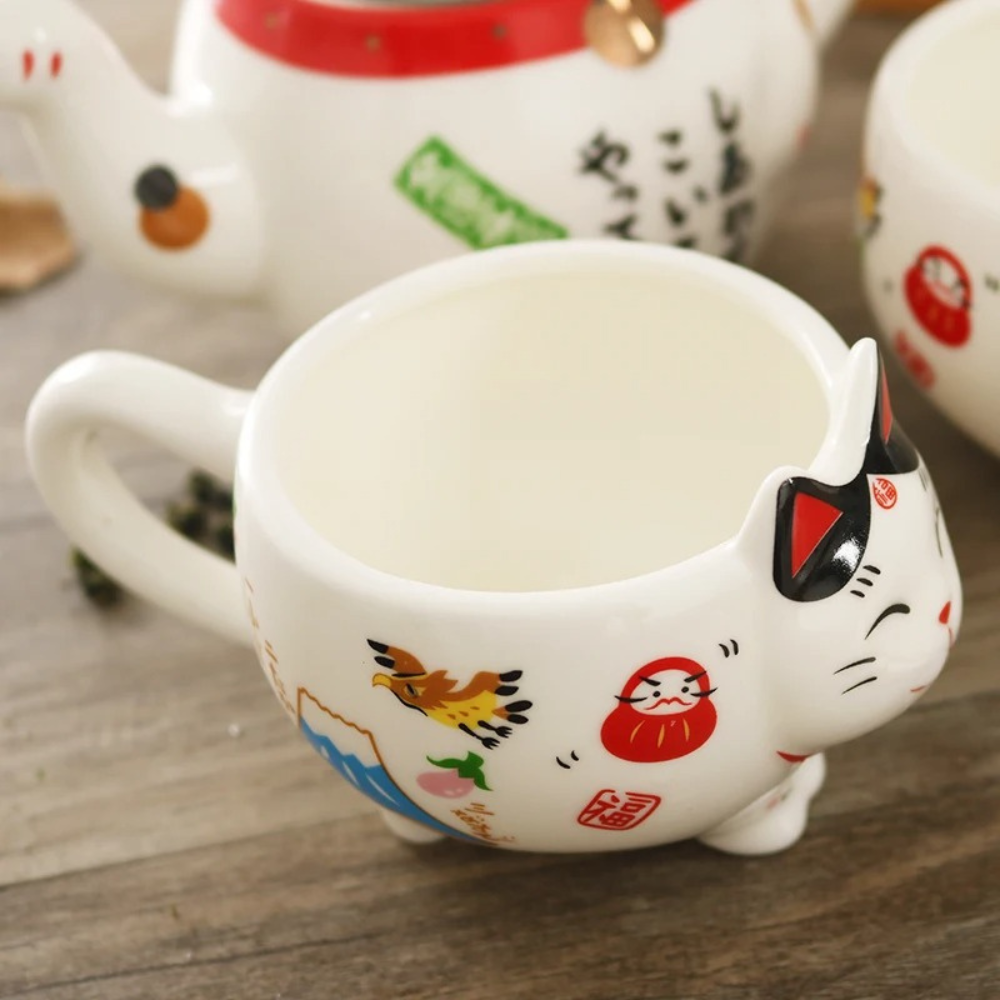 Two Maneki Neko tea cups on wooden tray with green tea