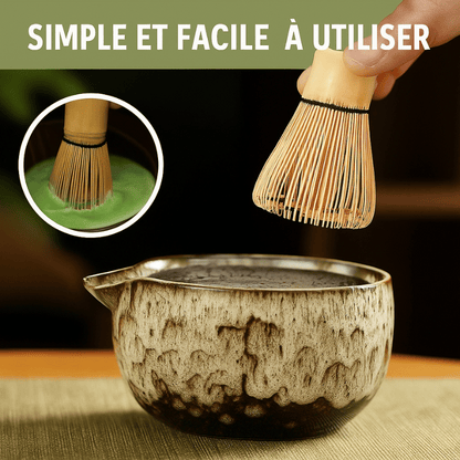 Bamboo chasen whisk and bamboo scoop resting beside ceramic matcha bowl with green tea powder