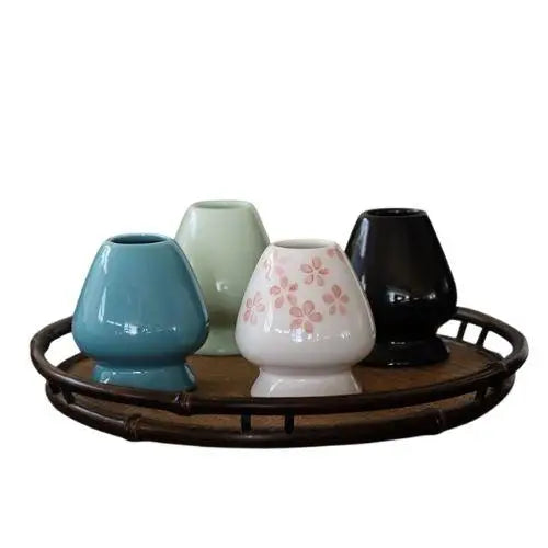 Green porcelain chasen stand holding bamboo matcha whisk upright