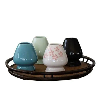 Green porcelain chasen stand holding bamboo matcha whisk upright