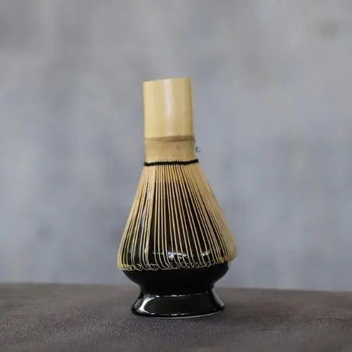 Porcelain chasen stand with bamboo whisk on wooden tea tray