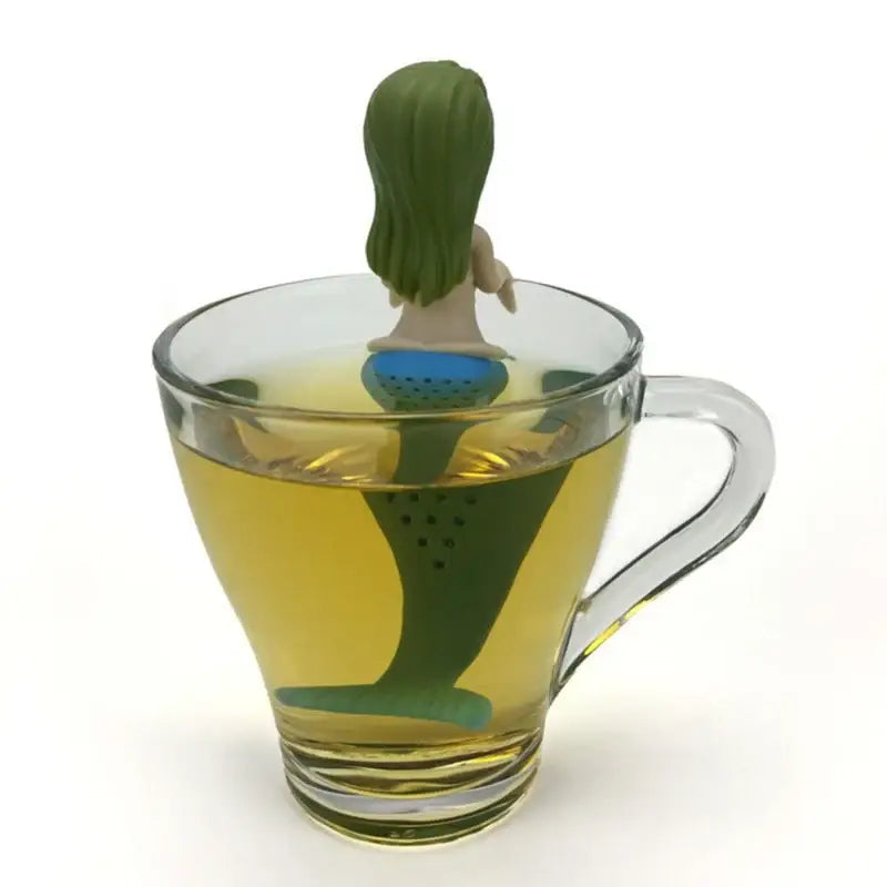 Green mermaid tea infuser with loose tea leaves