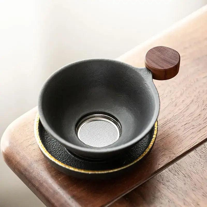 Mini tea strainer resting on a cup of hot tea