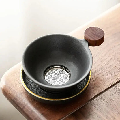 Mini tea strainer resting on a cup of hot tea