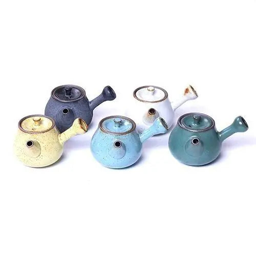 Set of colorful mini ceramic teapots in yellow, green, blue, white, gray