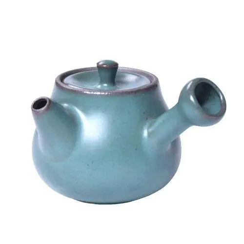 Green mini ceramic teapot with lid, perfect for solo tea