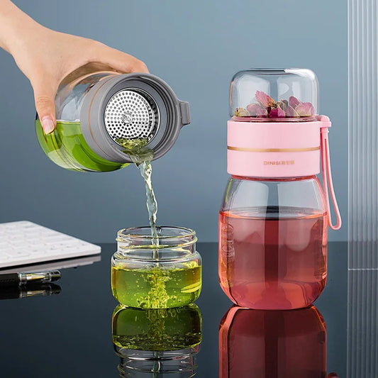 Glass teapot with stainless steel infuser filled with loose leaf green tea