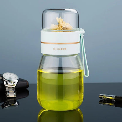 Mini glass teapot with infuser beside a ceramic teacup, 450ml size