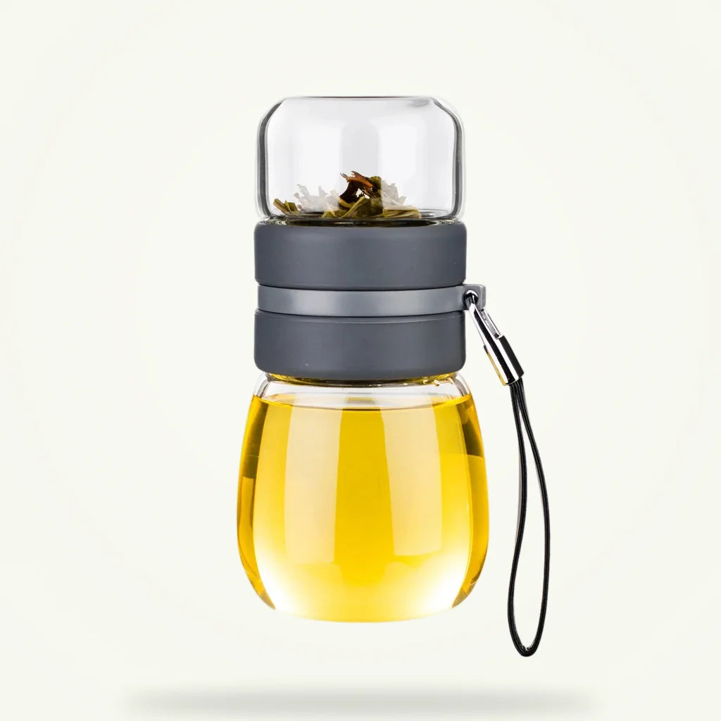 Mini glass teapot with infuser for loose leaf tea, 450ml, on plain background