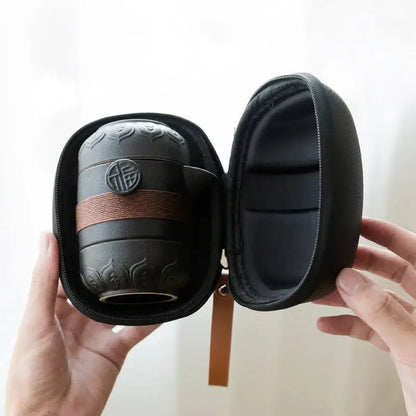 Portable ceramic tea set in matte black stoneware sized for carry-on travel
