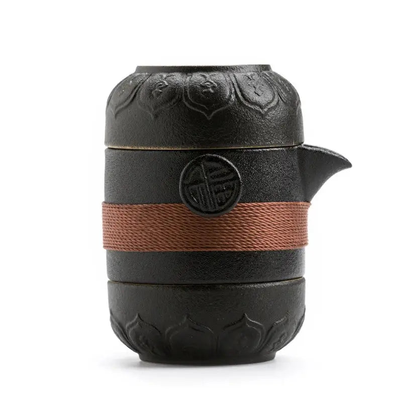 Top view of mini travel tea set with teapot and two cups arranged together