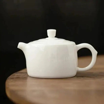 Small porcelain teapot with cup, perfect for single serving
