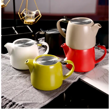 Modern ceramic teapot in beige on a table