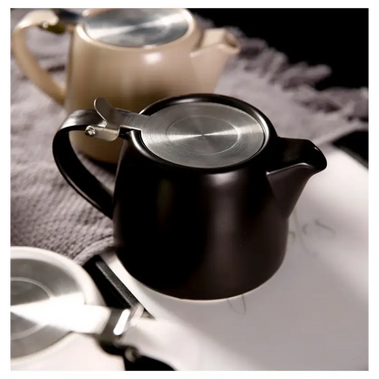 Modern ceramic teapot with cup on tray