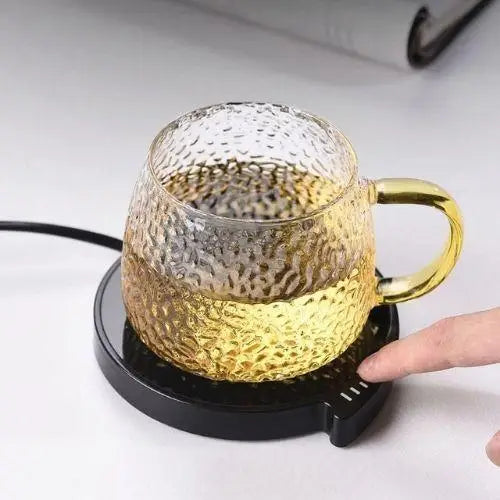 Cup warmer keeping a mug of tea warm on a desk