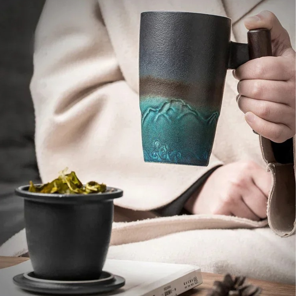 Ceramic teapot with stainless steel infuser for loose-leaf tea, close-up detail