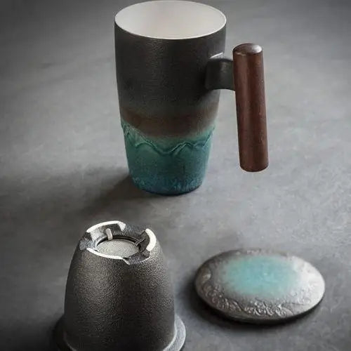 Ceramic tea pot for one placed on wooden surface, showing full profile with lid