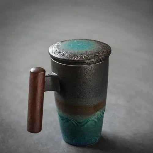 Green-toned ceramic teapot with infuser and lid, lifestyle shot on natural background