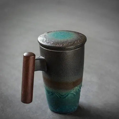 Green-toned ceramic teapot with infuser and lid, lifestyle shot on natural background