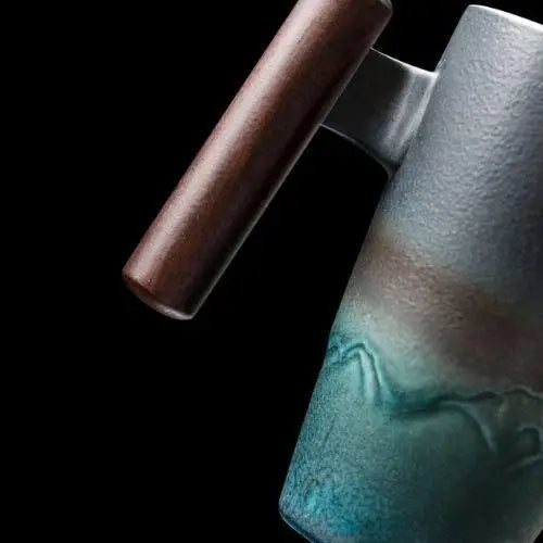 Ceramic teapot handle detail showing ergonomic grip and glaze finish