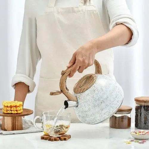 Person using vintage cream teapot
