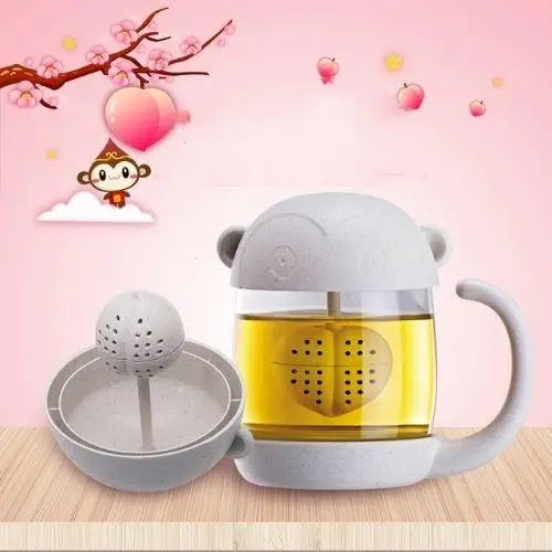 Monkey glass tea cup with infuser basket shown separately