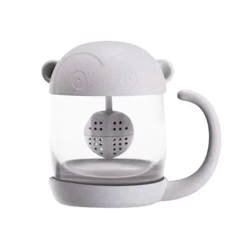 Front view of clear glass monkey tea cup with infuser