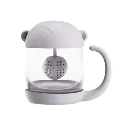 Front view of clear glass monkey tea cup with infuser