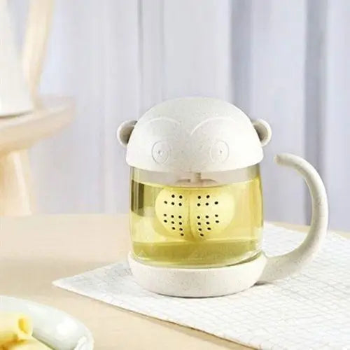 Monkey glass tea cup in use with loose-leaf tea steeping